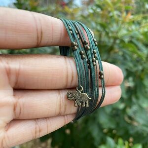 Green handmade macrame bracelet with elephant charm